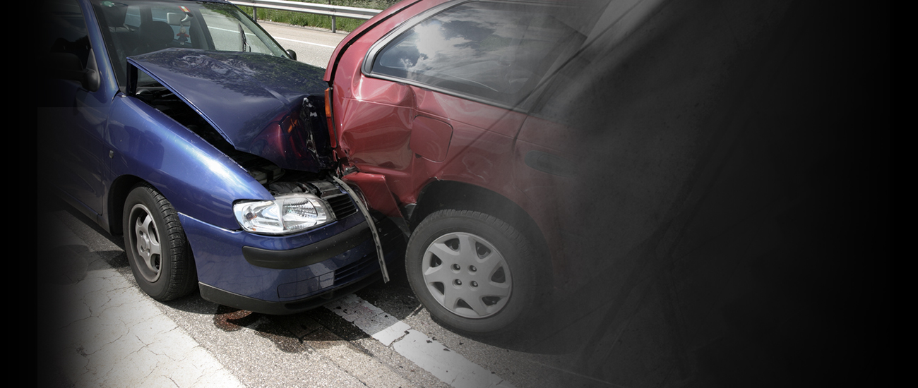 Photograph of a rear-end collision involving a blue car and a red truck.